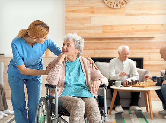 Nurses assisting elderly for long-term care in nursing home